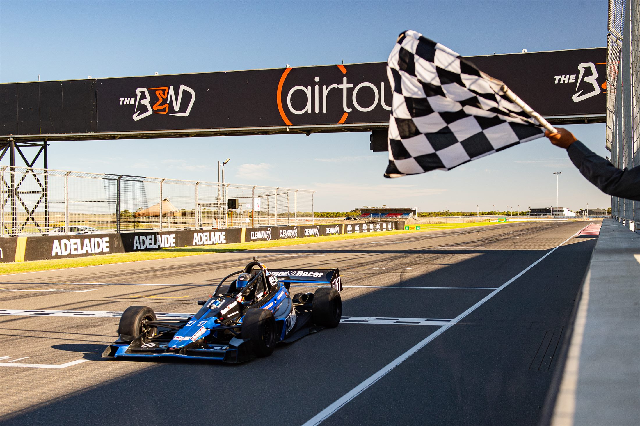 X1 taking the chequered flag